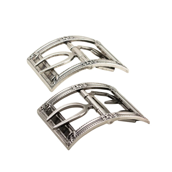 Two silver belt buckles on a white background
